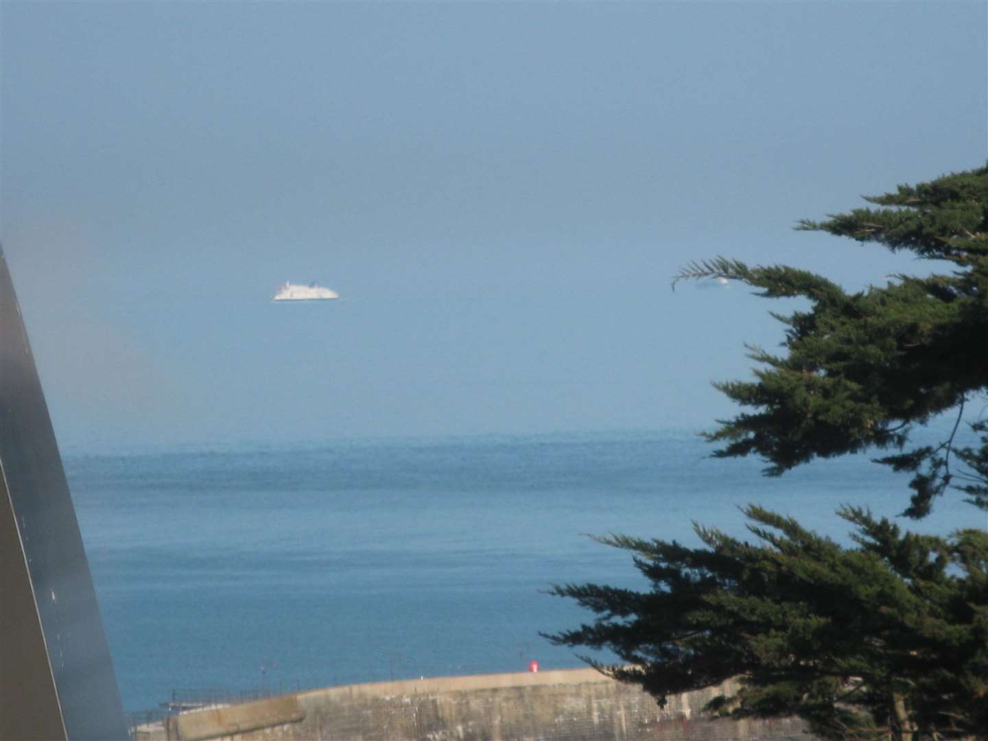 Pat Cocks took this photo of what appears to be a 'floating ship' in Folkestone. A second ship can also be seen behind the tree