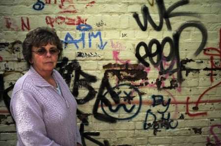 Gill Kilner with the graffiti on the side of her property