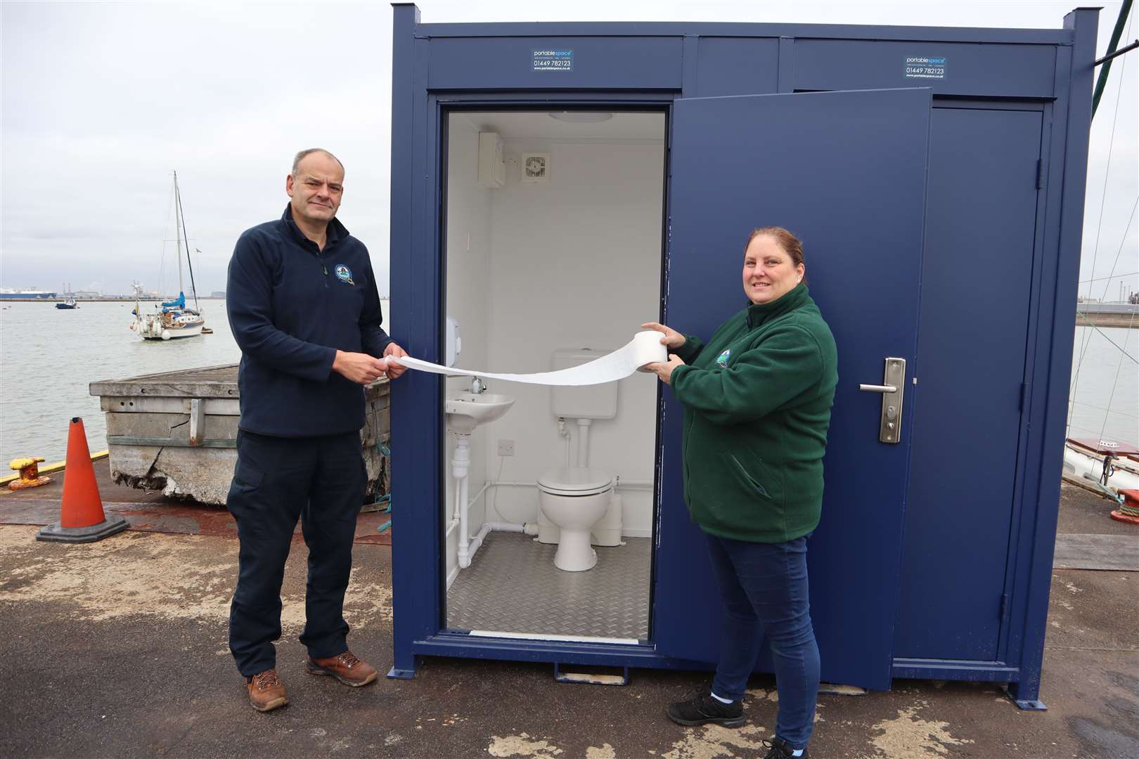 David Lavender and Rachel Collier 'baptising' the new solar loos on Queenborough Harbour's pontoon
