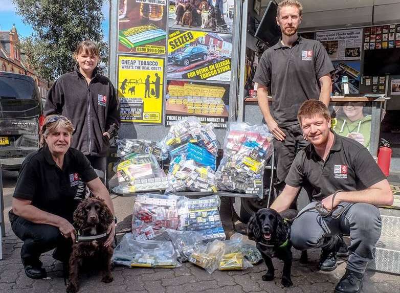 Kent Trading Standards officers with Phoebe and Yoyo and a haul of tobacco found in Gravesend. Picture: Kent County Council