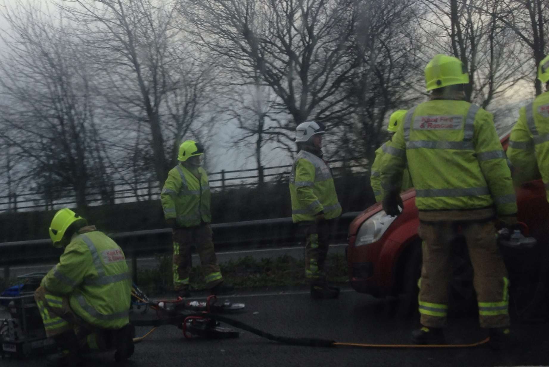 Firefighters at the scene of a crash on the M2
