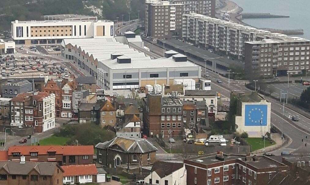 St James' in the context of central Dover with the Gateway Flats, seafront and Banksy mural
