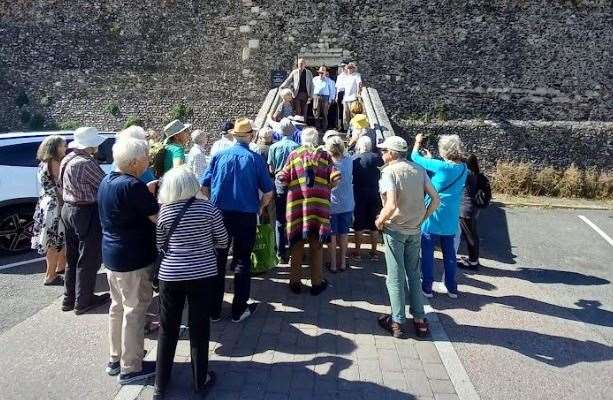 A crowd gathers for the formal reopening of the historic Quenin Gate entrance to the Cathedral Precincts