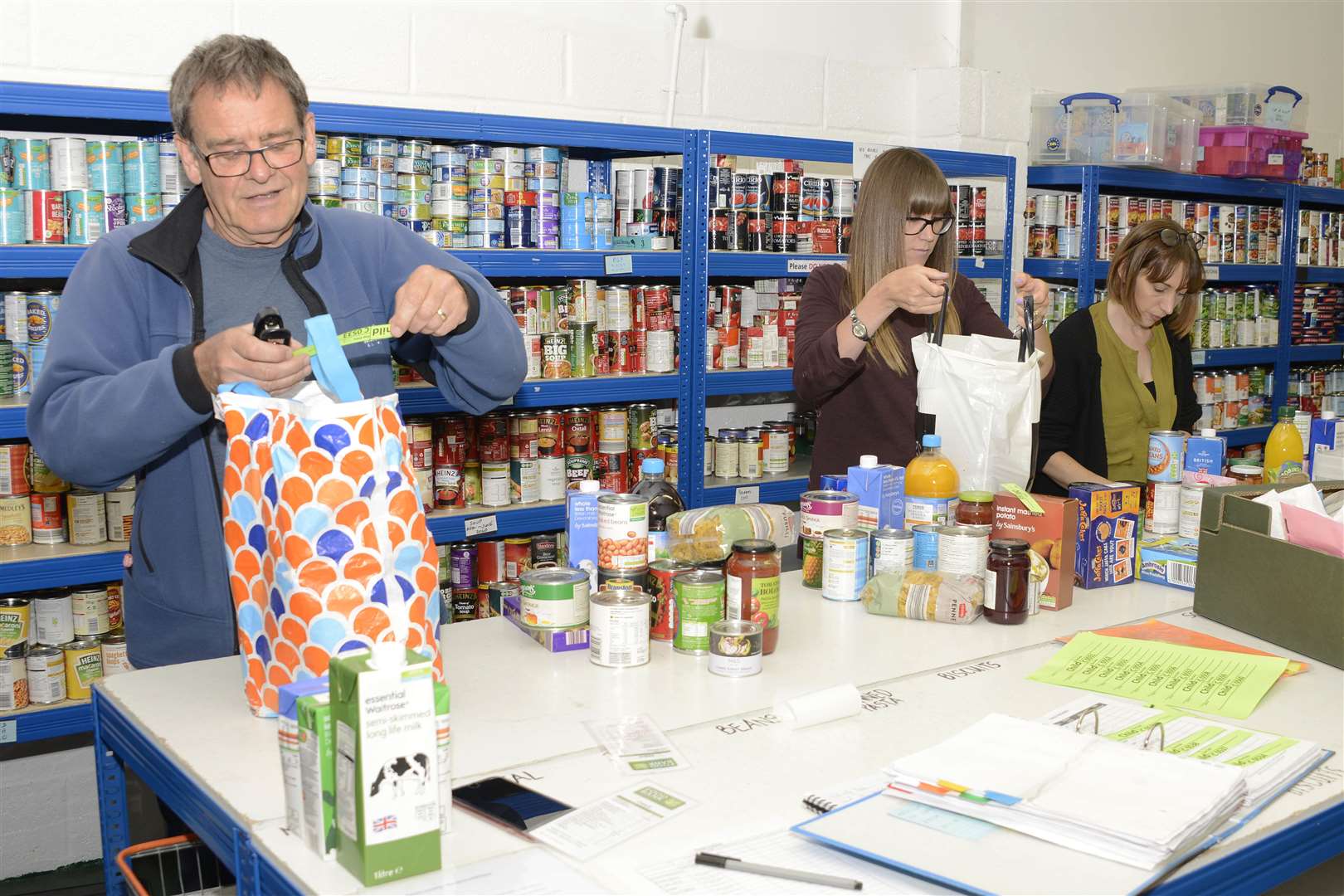 Volunteers packing donations into food parcels at Canterbury Food Bank's warehouse last June