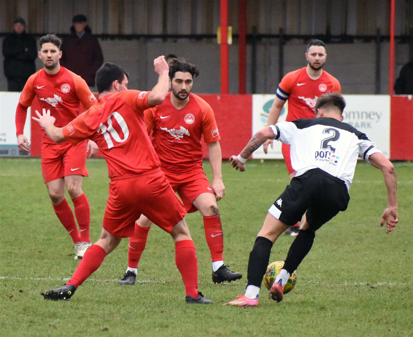 Alex Brown, centre, in action against Faversham, is staying at Hythe Picture: Randolph File