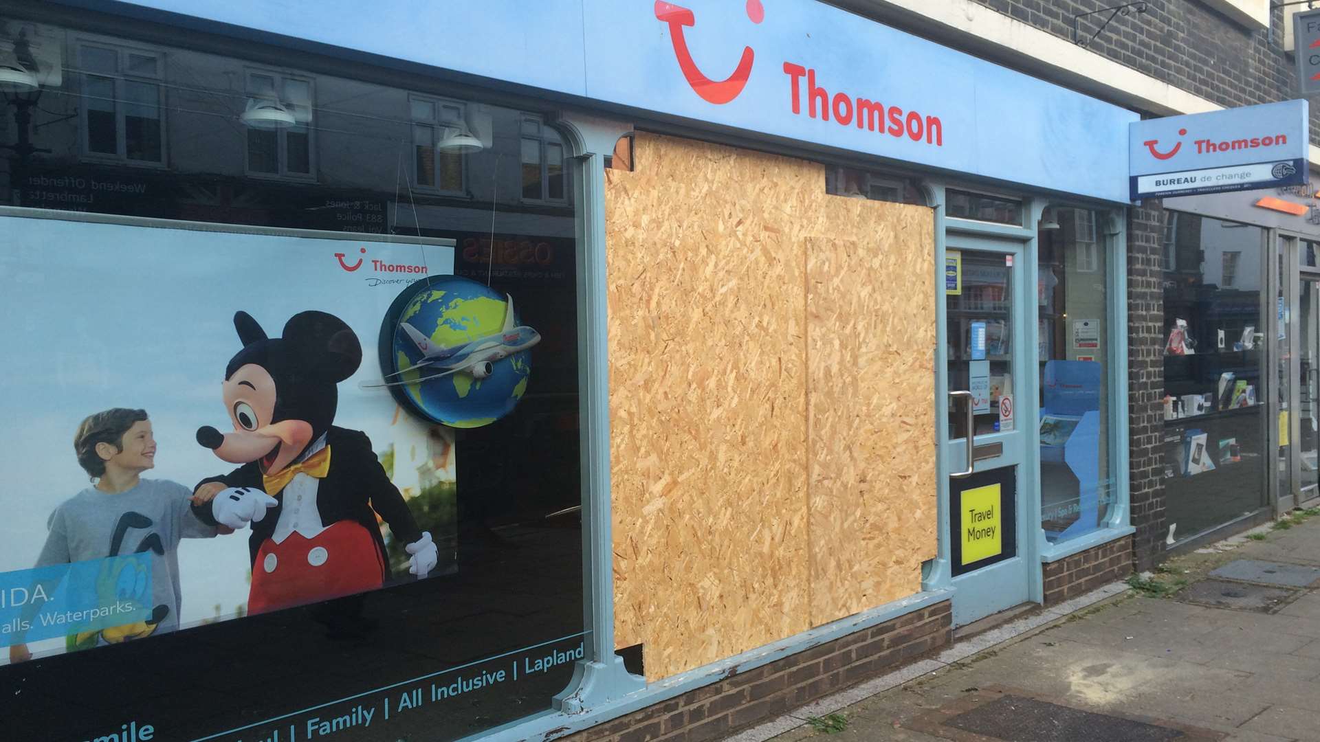 Thomson travel agents had its window damaged.