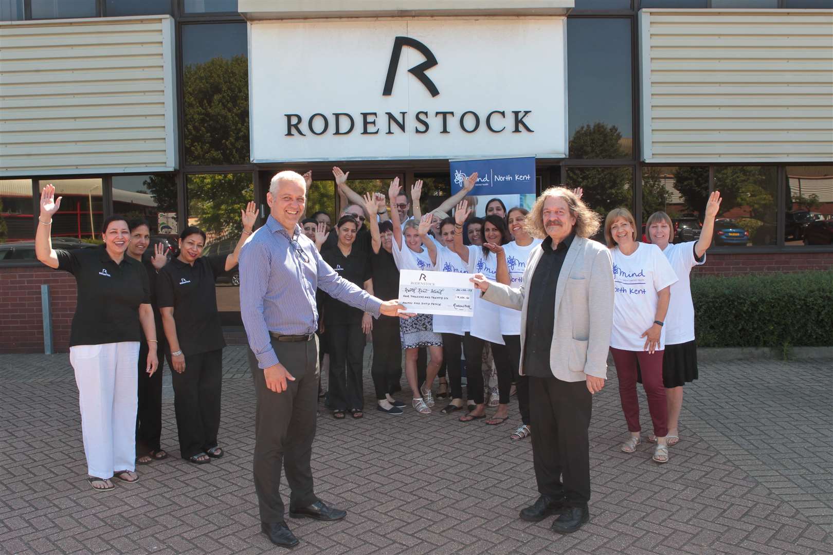 From left, Steve Beaty, ICT Manager hands over a cheque for Â£4026, to Justin Bateman Chief Executive of North Kent MIND, on behalf of the Rodenstock employees, who raised the money from walking from the company premises six plus miles to the Dartford Temple. Picture by: John Westhrop. (2747183)