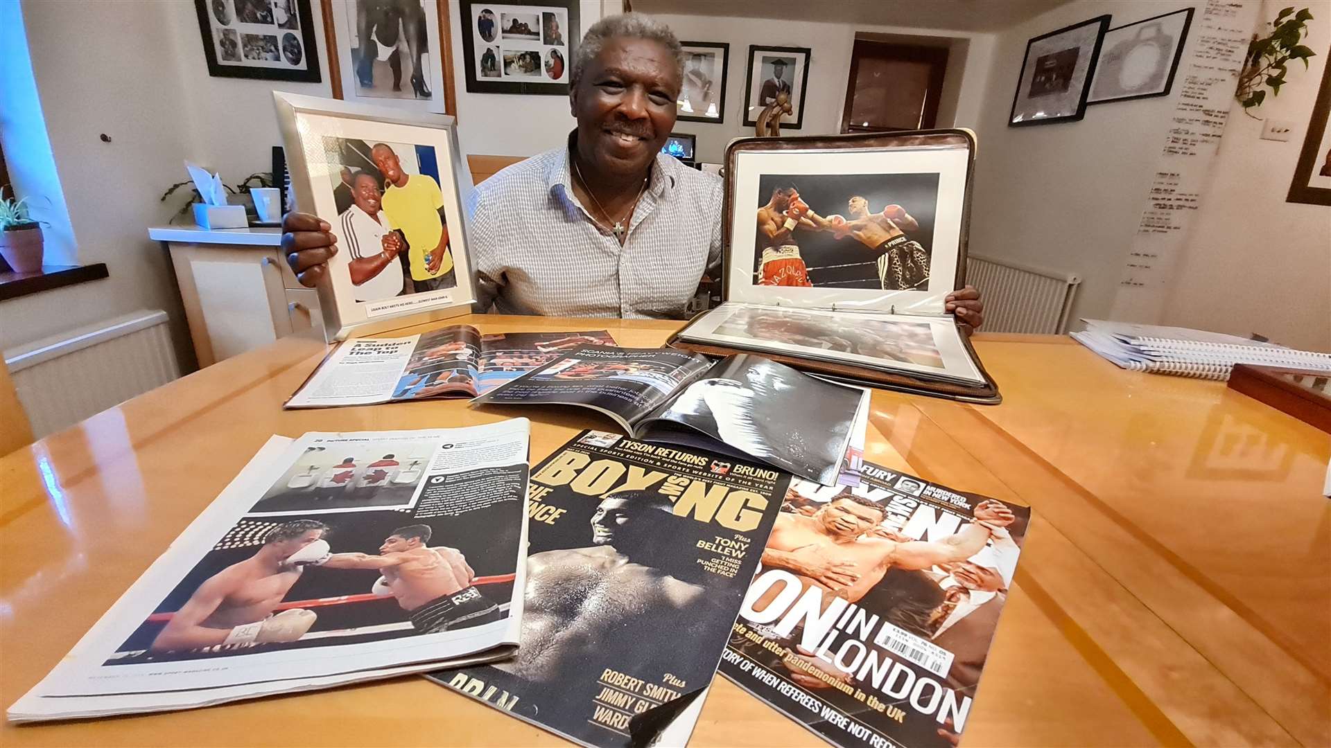 John Gichigi at home with just a fraction of his work