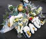 Floral tributes to Mr Baker remain at the scene of the attack