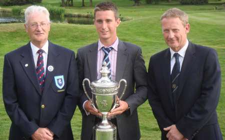 Michael Saunders receives the cup from Kent County Golf Union president Chris Tappin and Langley Park Golf Club captain Chris Gimson