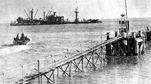 The wrecked Liberty Ship SS James Harrod between Deal's Pier and castle with a Dukw - otherwise known as a Duck - heading towards it to continue the salvage operation