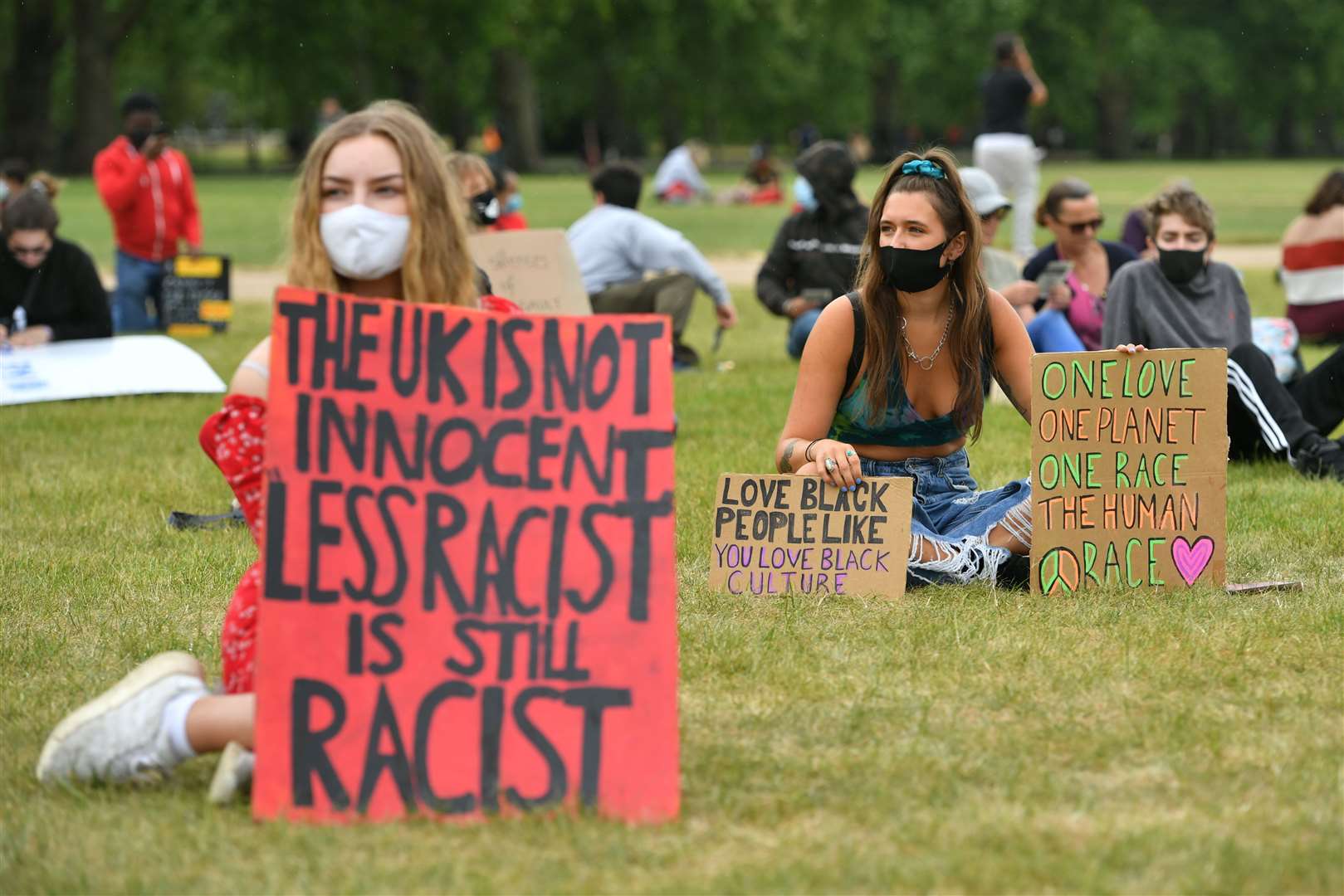 Protesters hold banners in Hyde Park (Dominic Lipinski/PA)
