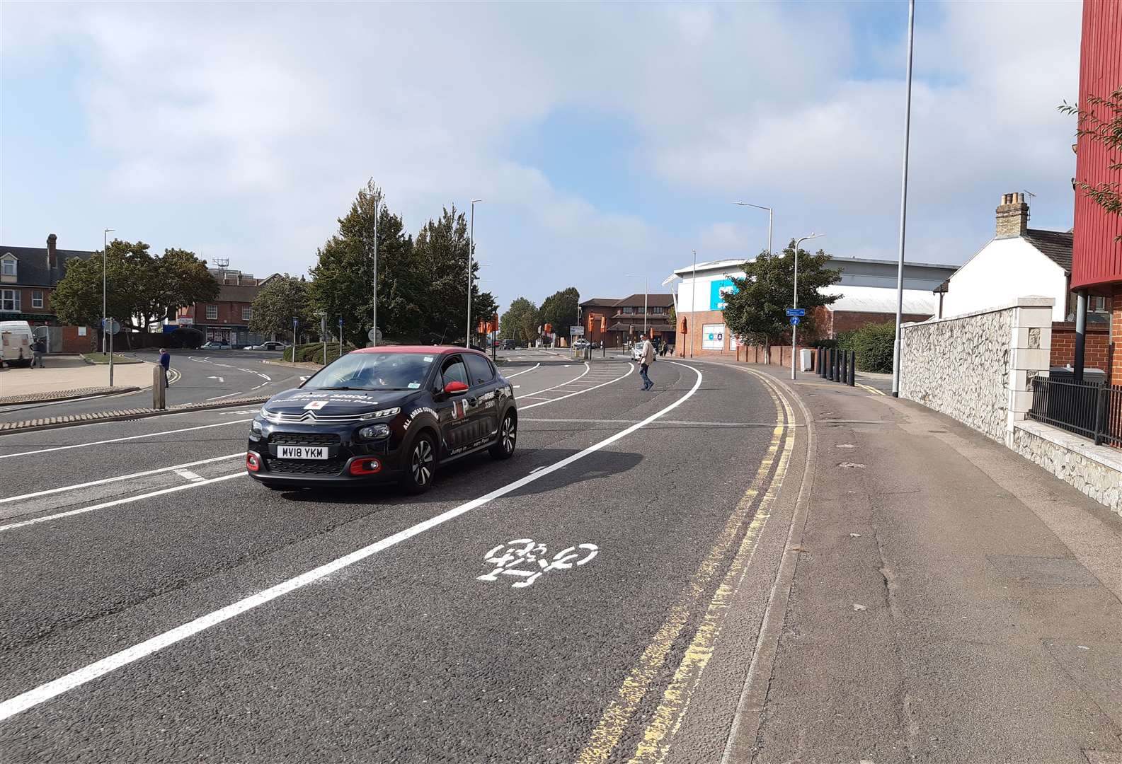 Bollards have now been removed and all lanes are open again, but bicycle road markings still remain