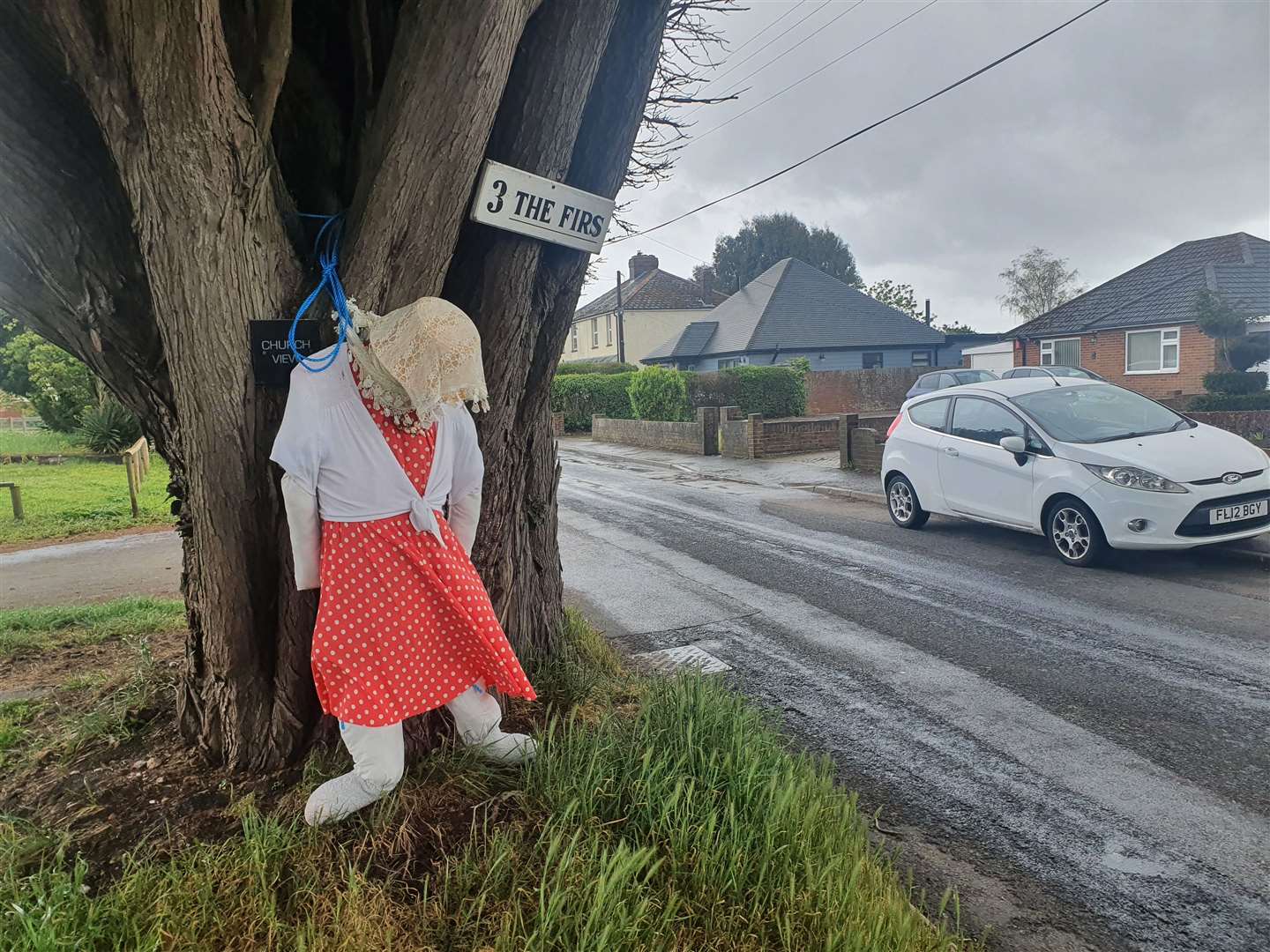 A colourfully-dressed scarecrow in The Firs