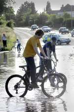 Boys enjoy the flooded A20