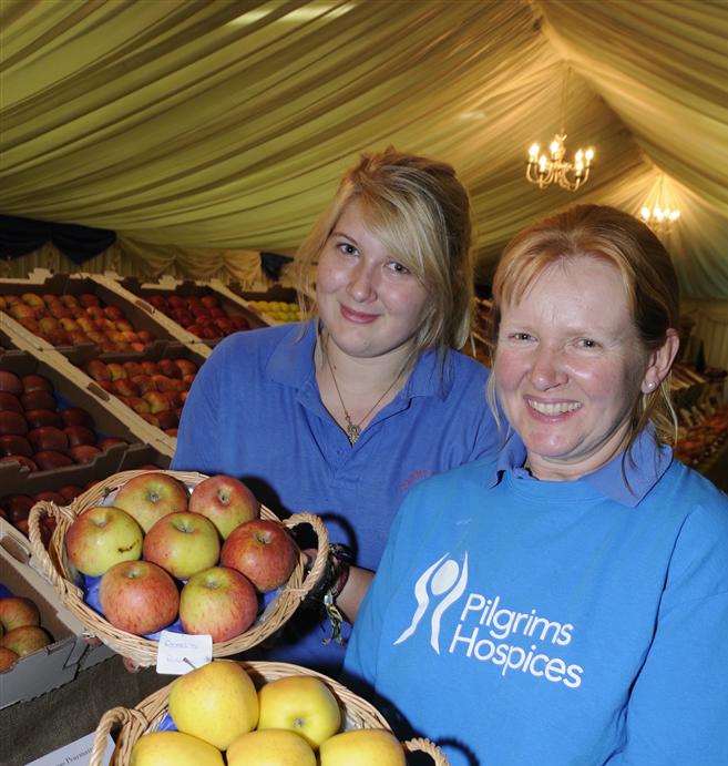Heidi Fermor and daughter Cherry with some of the many apples on display at Perry Court Farm over the weekend