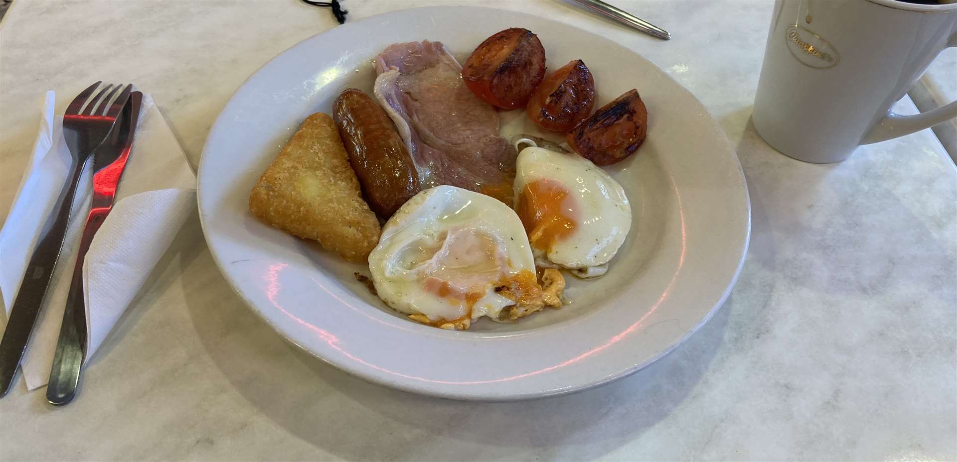 A full English minus beans and mushrooms with a large black coffee