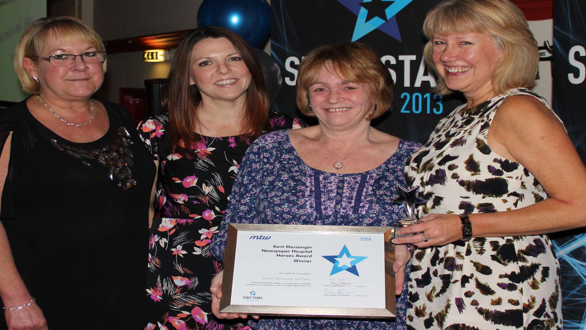 Kent Messenger editor Denise Eaton presents the accolade to the Kent Oncology Centre team at last year's awards