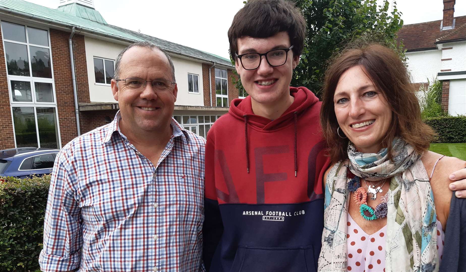 Struben Savage from Tenterden achieved seven GCSEs at grade 9, and two at Grade 7. He is pictured with his parents Mark and Andrea