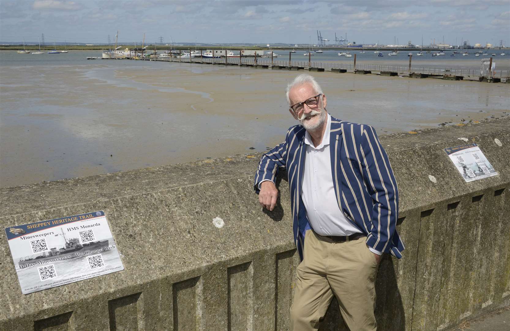 The heritage trail organiser, John Jones, by the signs at Queenborough's sea wall. Picture: Paul Amos