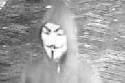 A CCTV image of a masked man approaching students in Canterbury