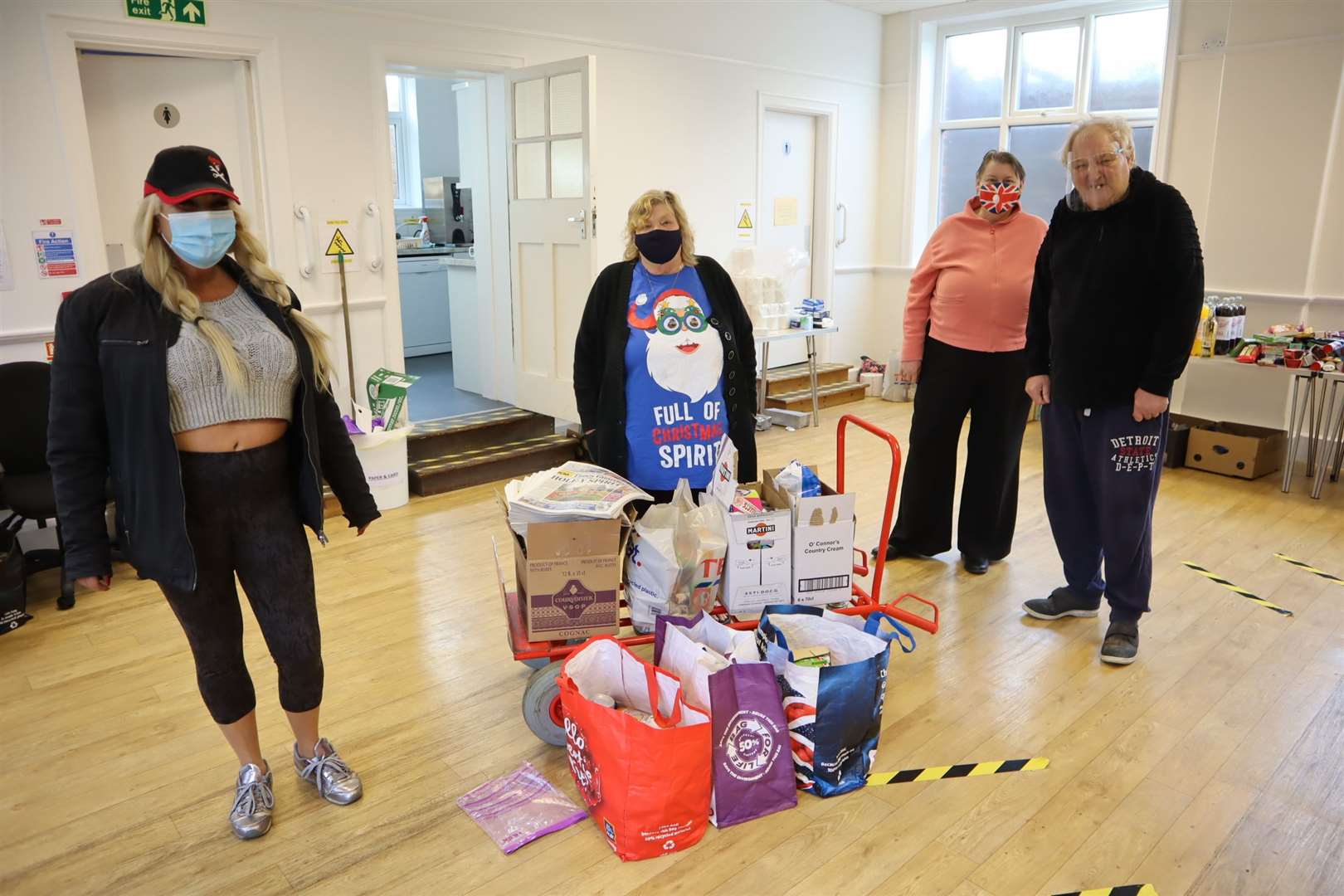 Care 4 Christmas on Sheppey volunteers Karena Chetwynd, left, Carol Wraight, centre, and married couple Barbara and David Coombes with free copies of the Sheerness Times Guardian