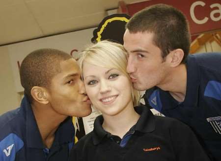 Gills players Simeon Jackson and John Nutter give Sainsbury's employee Lauren Moody a Valentine’s kiss. Picture: PETER STILL