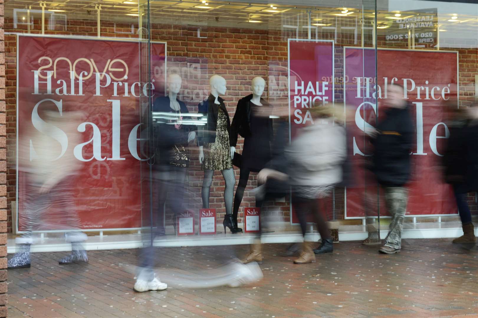 Shoppers and sales posters, outside Debenhams store, High Street, Chatham