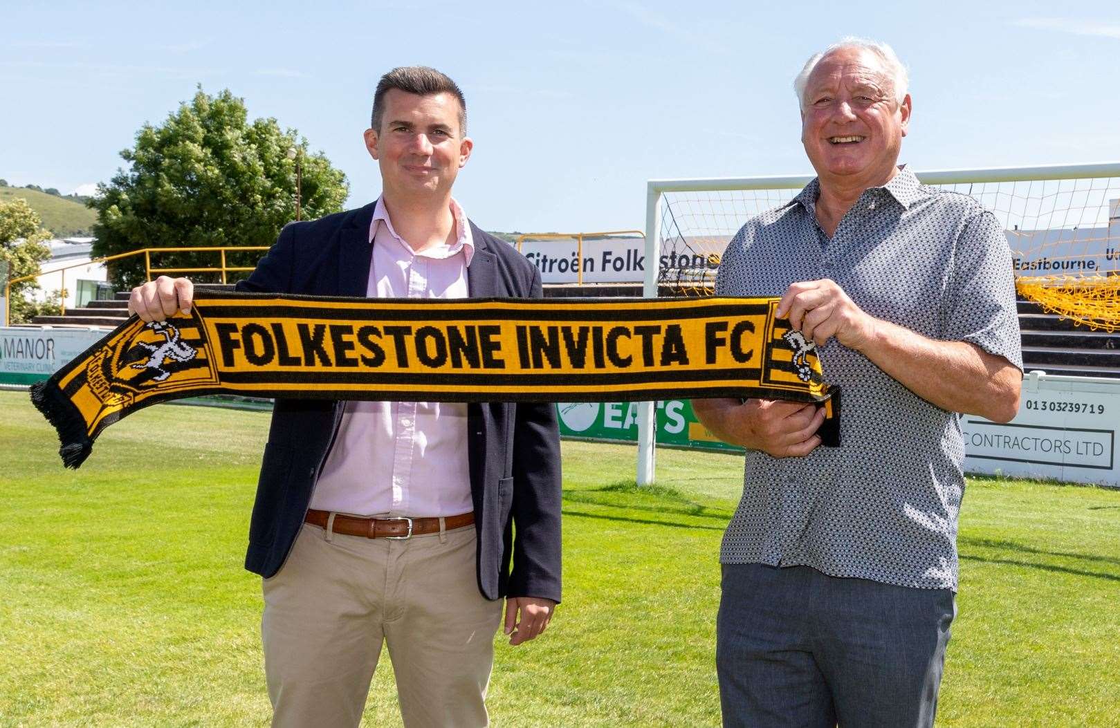 Josh Healey and Folkestone Invicta director of football Neil Cugley are all smiles