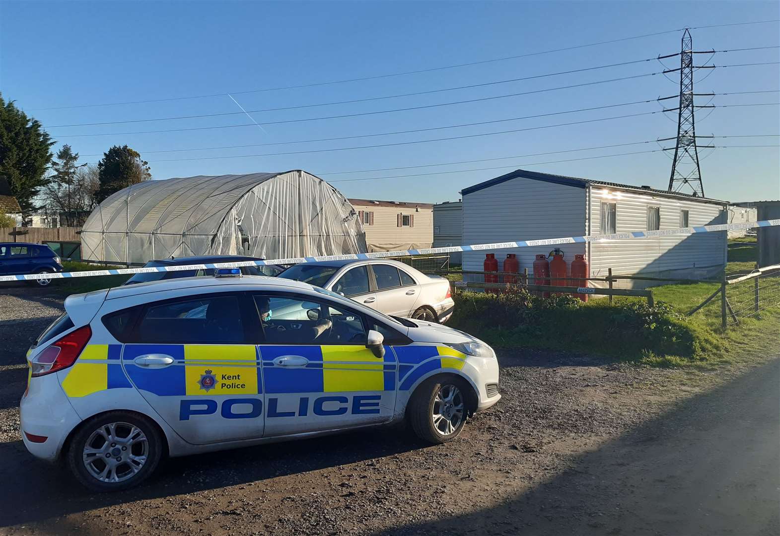 Three arrests as police probe 'unexplained' death near farm