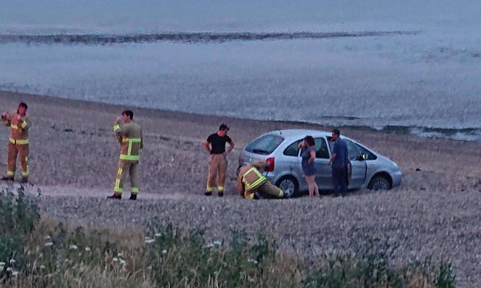 Firefighters were called to the shingle bank at Minster to help the stranded car. Picture: Stuart H