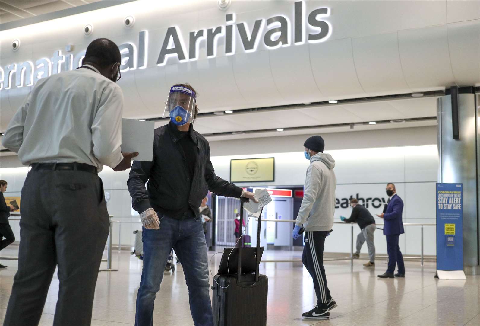 Passengers arriving at airports had to deal with a changing set of quarantine and travel corridor restrictions through the year (Steve Parsons/PA)