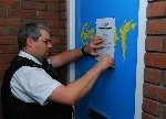 Beat officer PC David Ward pins the closure notice to the front door of flat 53 Brunswick Street, Ramsgate. Nobody is allowed to live there for the next 12 weeks.