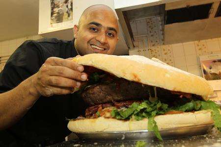 Sudeep De, Chef, showing the ingredients of a 11 kilo burger he made for Hamlets Hotel in Larkfield to celebrate the London 2012 Olympics.