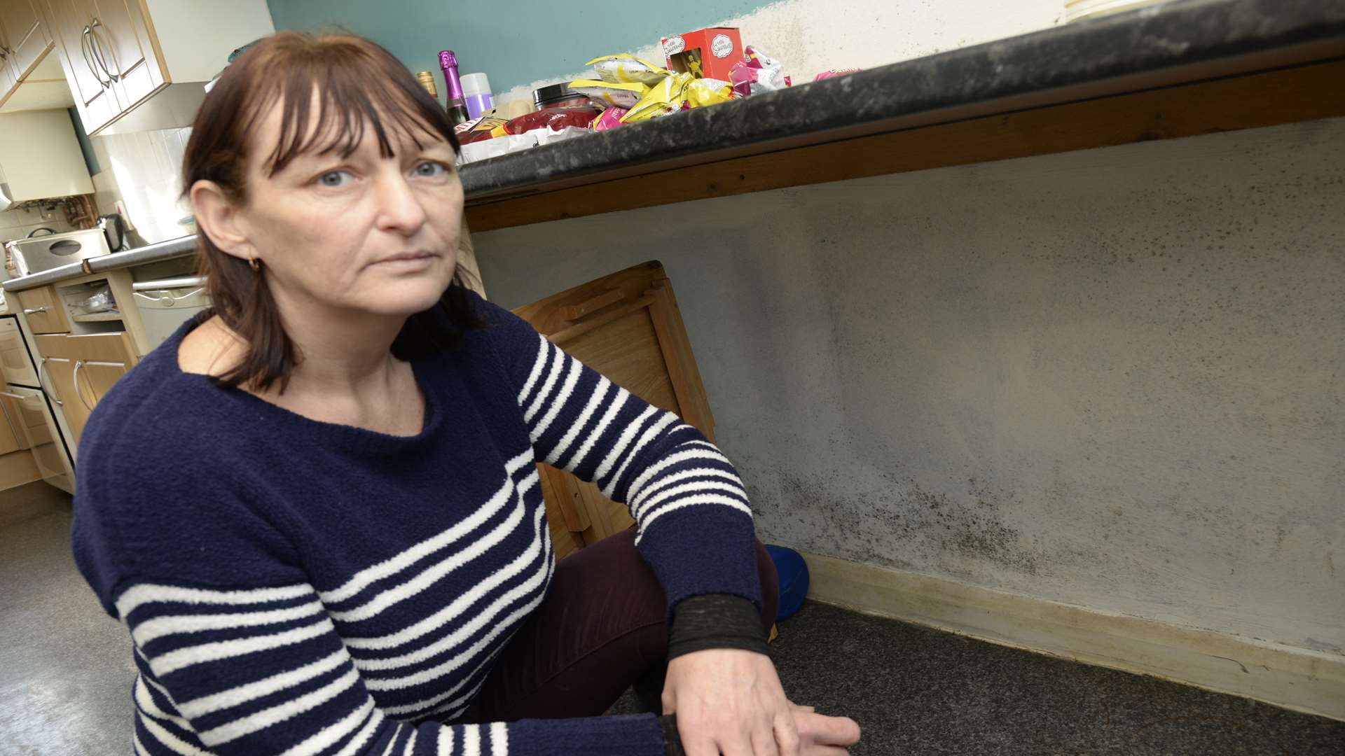 Hayley Flanagan in the kitchen of her house, which she says is riddled with mould.