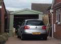 Man arrested after car ploughs into garage