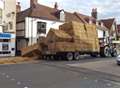 Cars, traffic light and lamppost crushed by falling bales