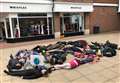 Protesters fake being dead outside shops