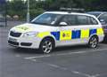 Police car with three flat tyres stranded in supermarket car park