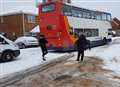 Father and son help dig double-deckers out of snow