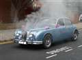 Fumes billow from funeral car