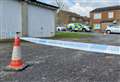 Police tape off garages after man stabbed in legs