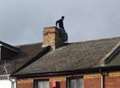 Alert after man climbs onto roof