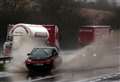 Cars aquaplaning on flooded road