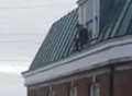Suspect evades police by climbing atop church