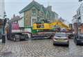 Truck carrying digger 'stuck' in city centre