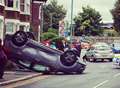 Car overturns in busy street