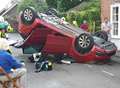 Man trapped after car crashes into wall and flips