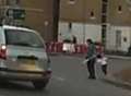 Shocking moment woman drags tot across roundabout