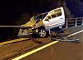 Drama as crashed car left hanging above motorway